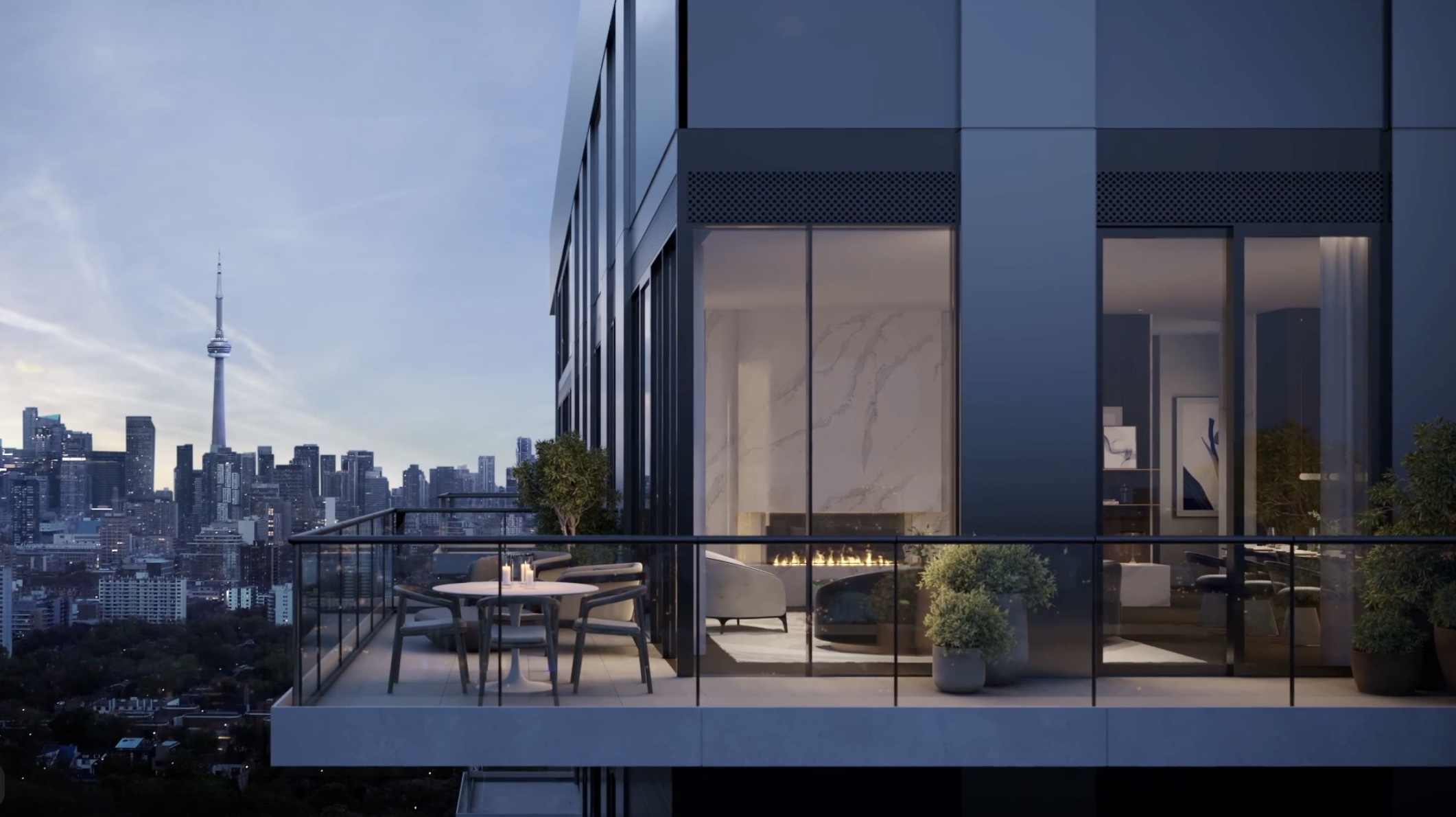Rendering of a Forêt Forest Hill terrace at dusk with a fireplace-lit suite and the downtown Toronto skyline and CN Tower beyond