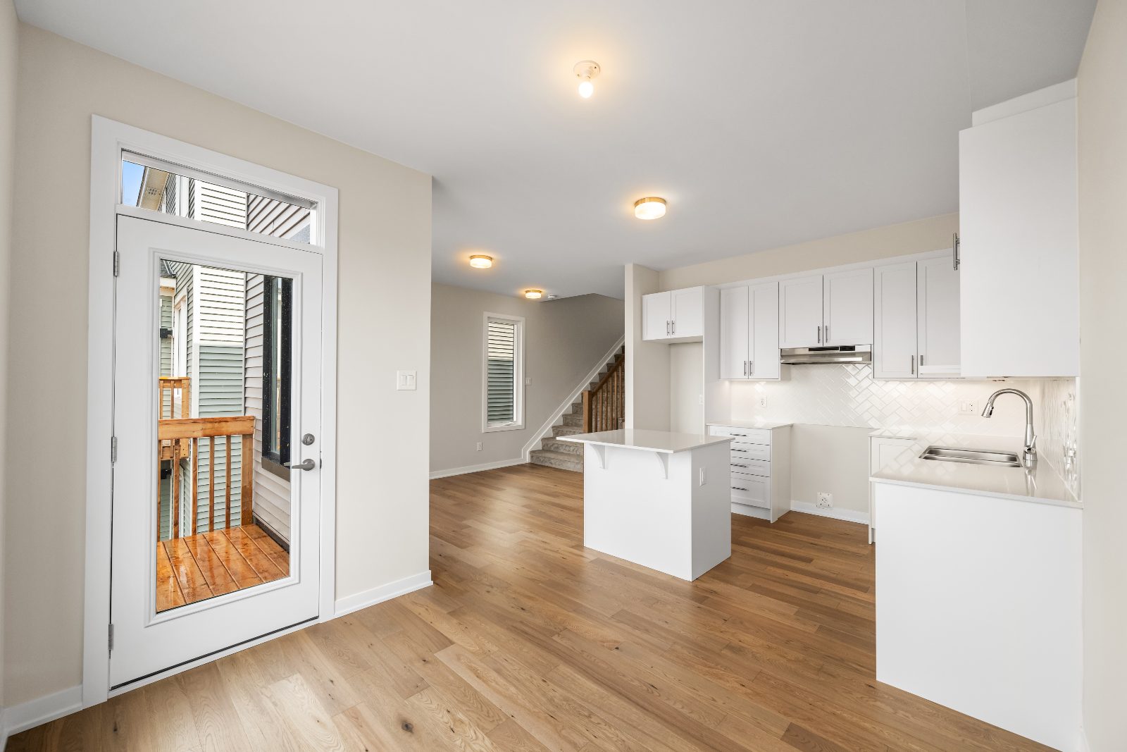 Open kitchen and living space with hardwood flooring