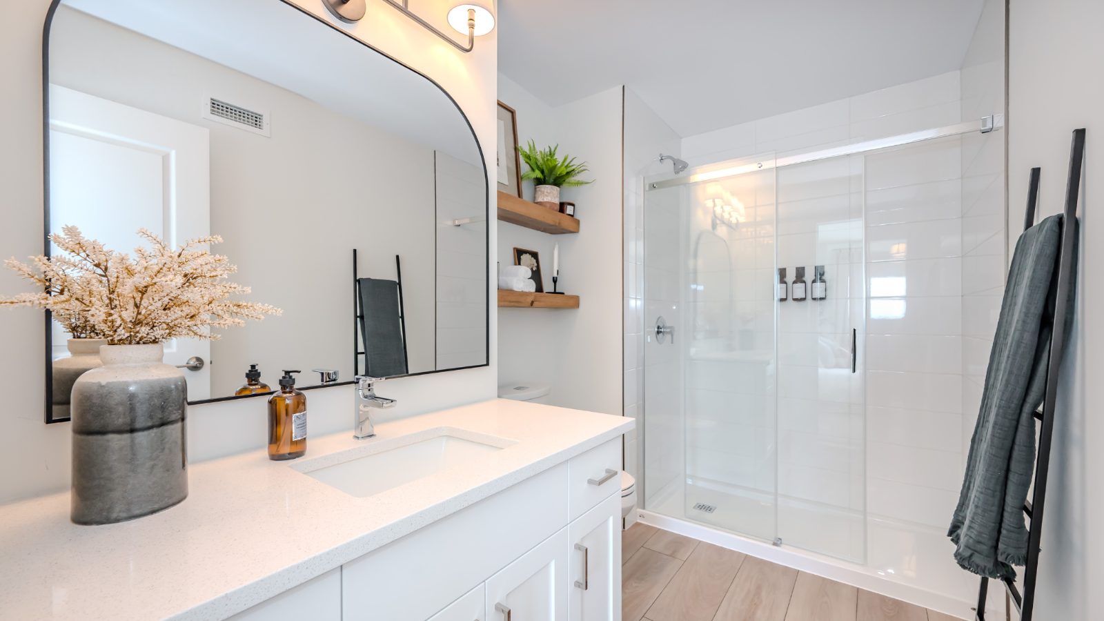 Spa-inspired bathroom with glass shower and quartz vanity