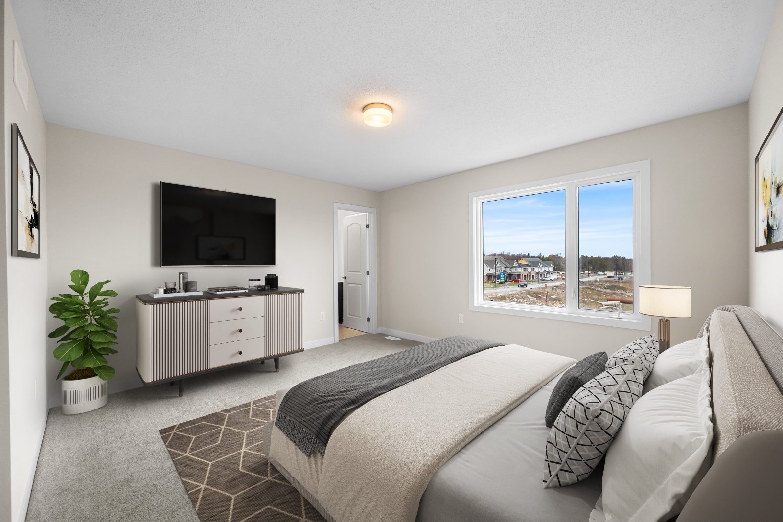 Primary bedroom with large window and neighbourhood view