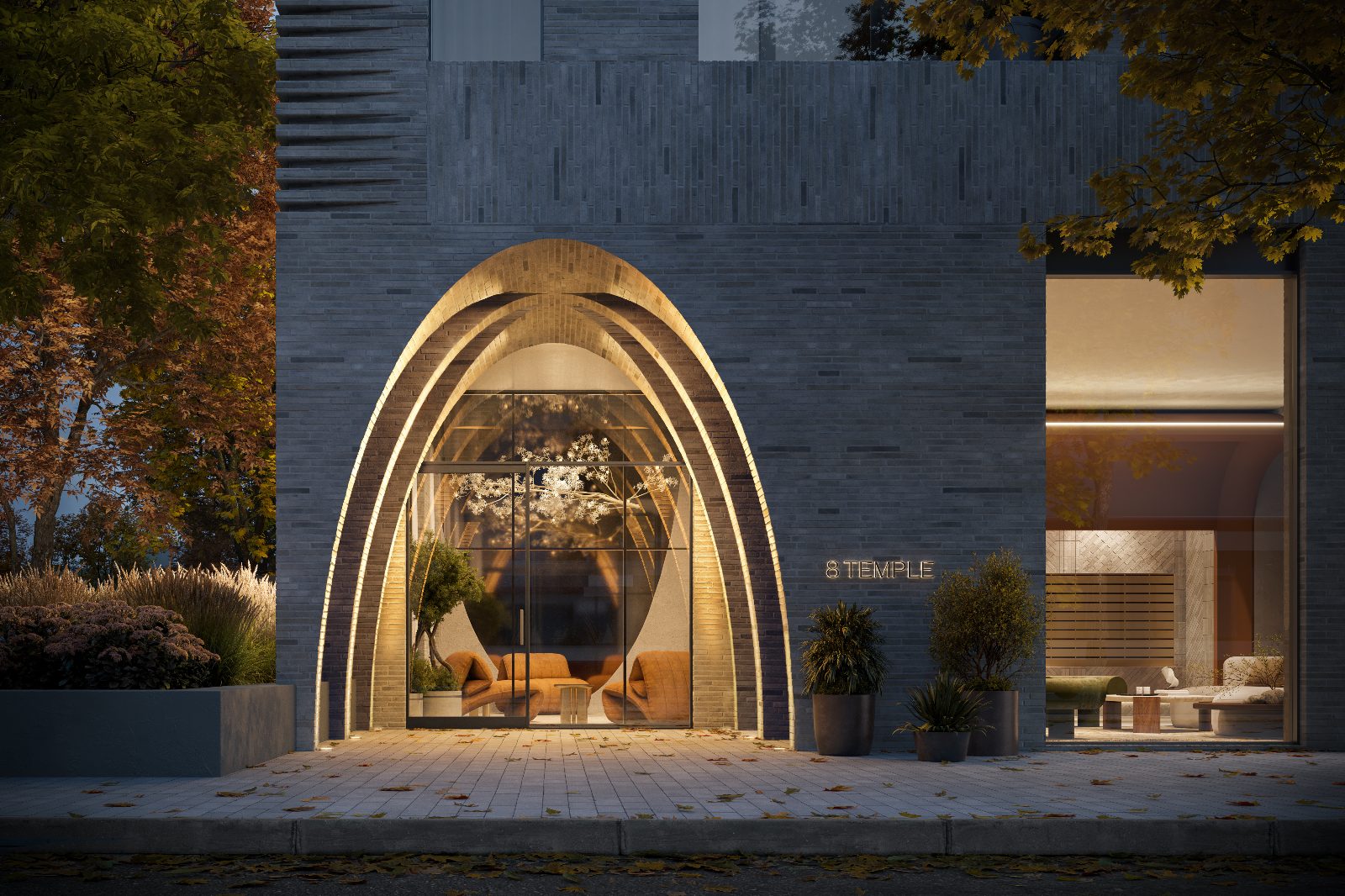 Illuminated arched masonry entrance to 8 Temple at dusk
