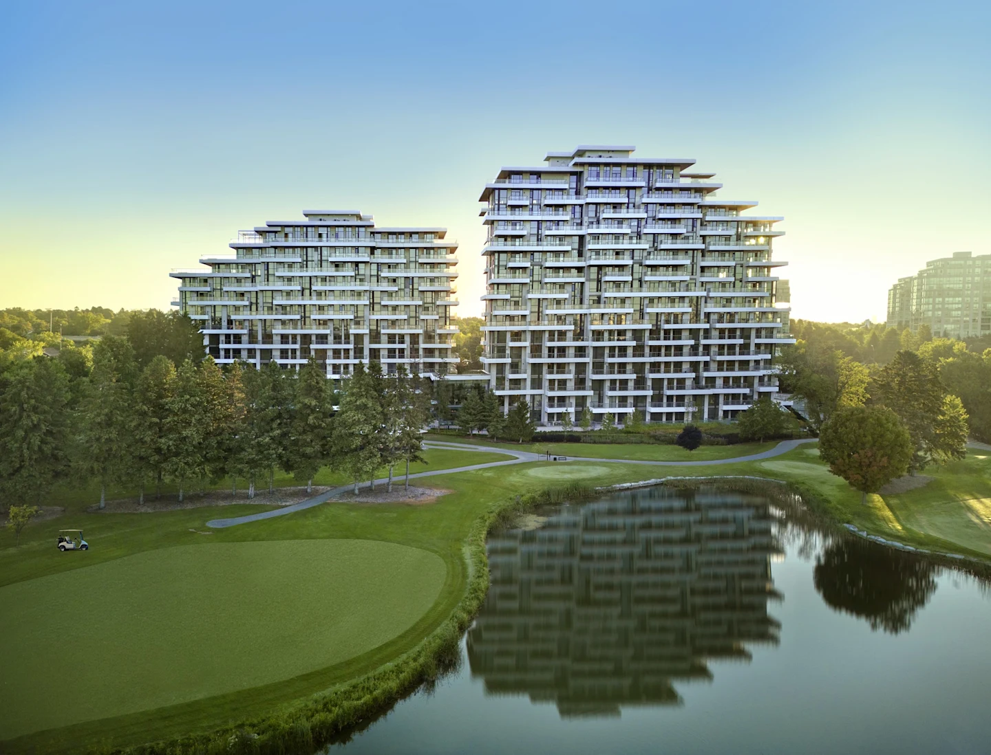 Royal Bayview's two completed terraced condominium buildings rising above the fairways and pond of the Ladies' Golf Club of Toronto at sunrise