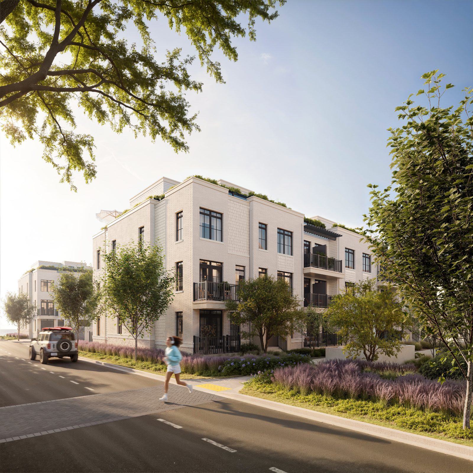 Artist's concept street view of South Banks townhomes with brick façade, balconies, rooftop greenery and lavender landscaping