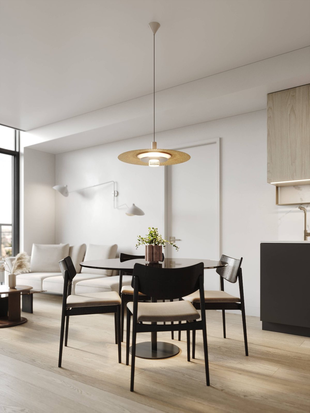 Suite dining area with pendant light, round table and wood-grain kitchen cabinetry
