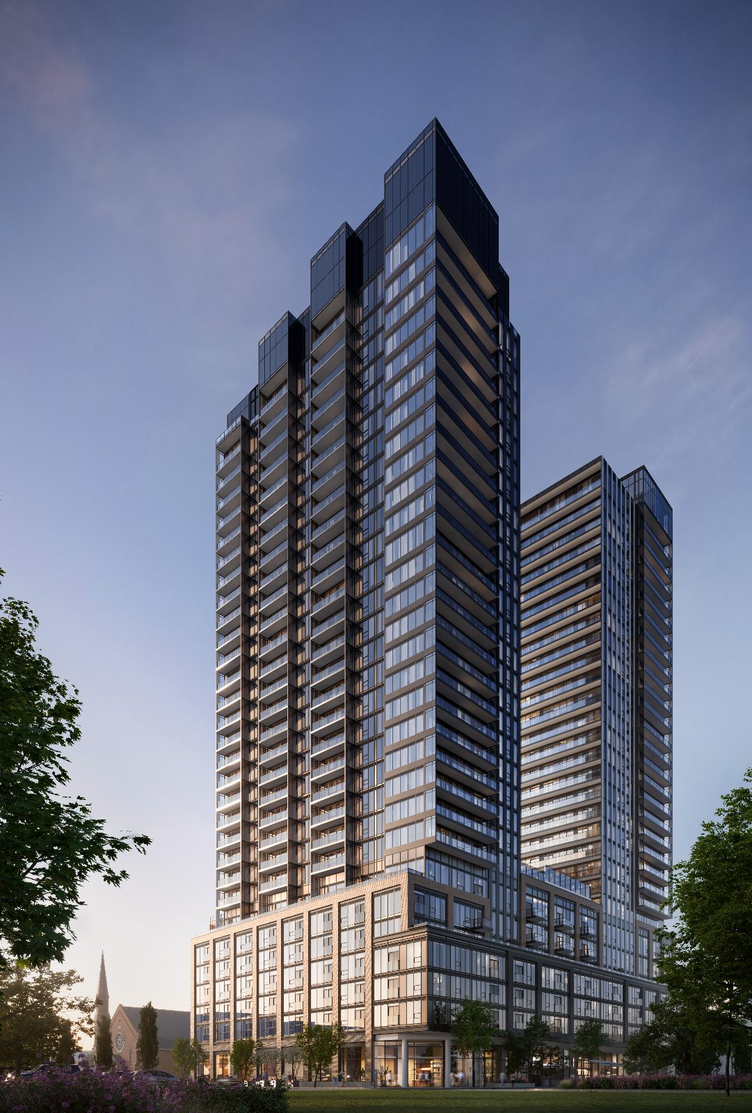 Tower 1 at The Design District at dusk with its sculpted, stepped crown