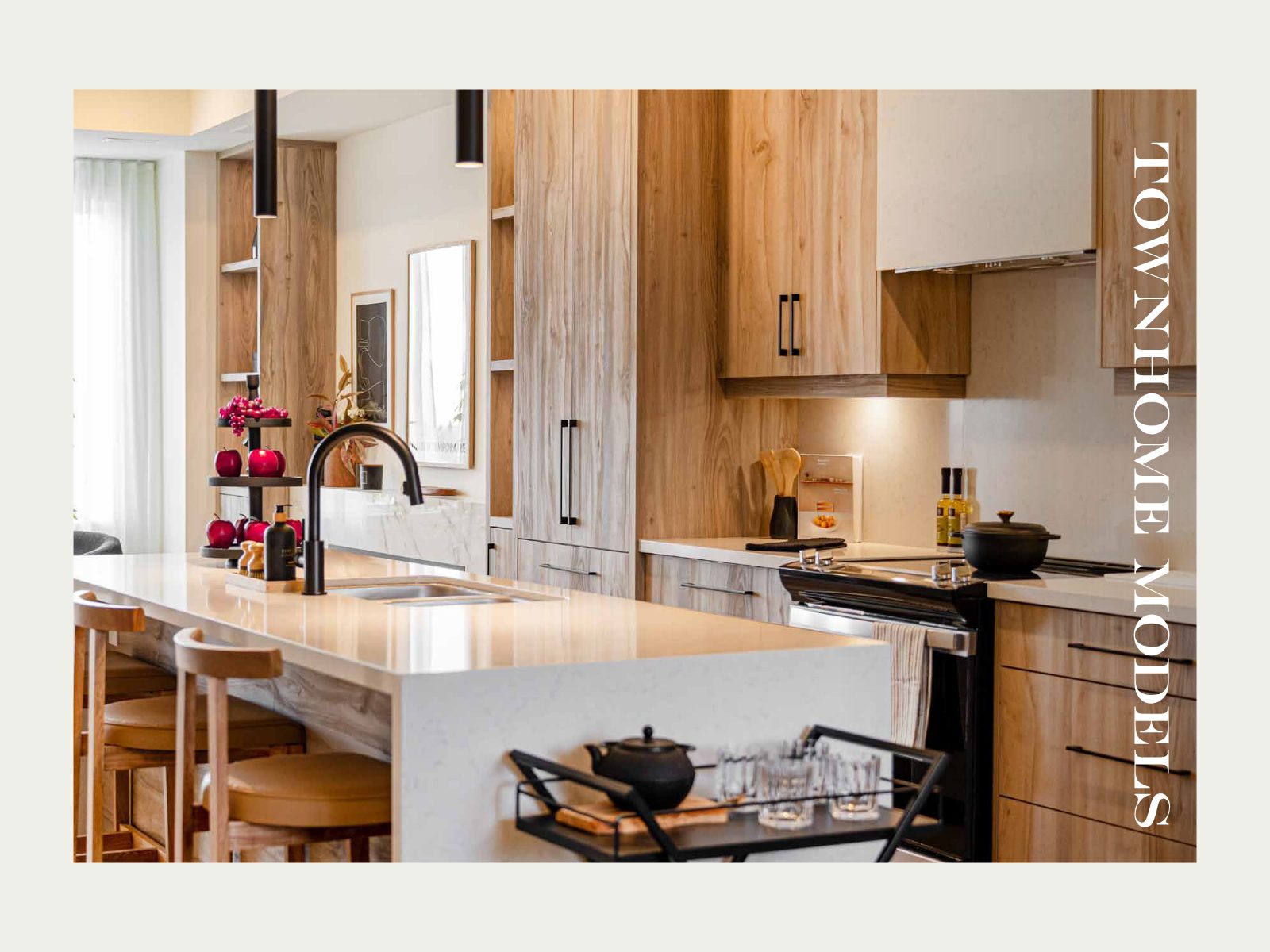 Bright townhome kitchen with quartz island and warm wood cabinetry