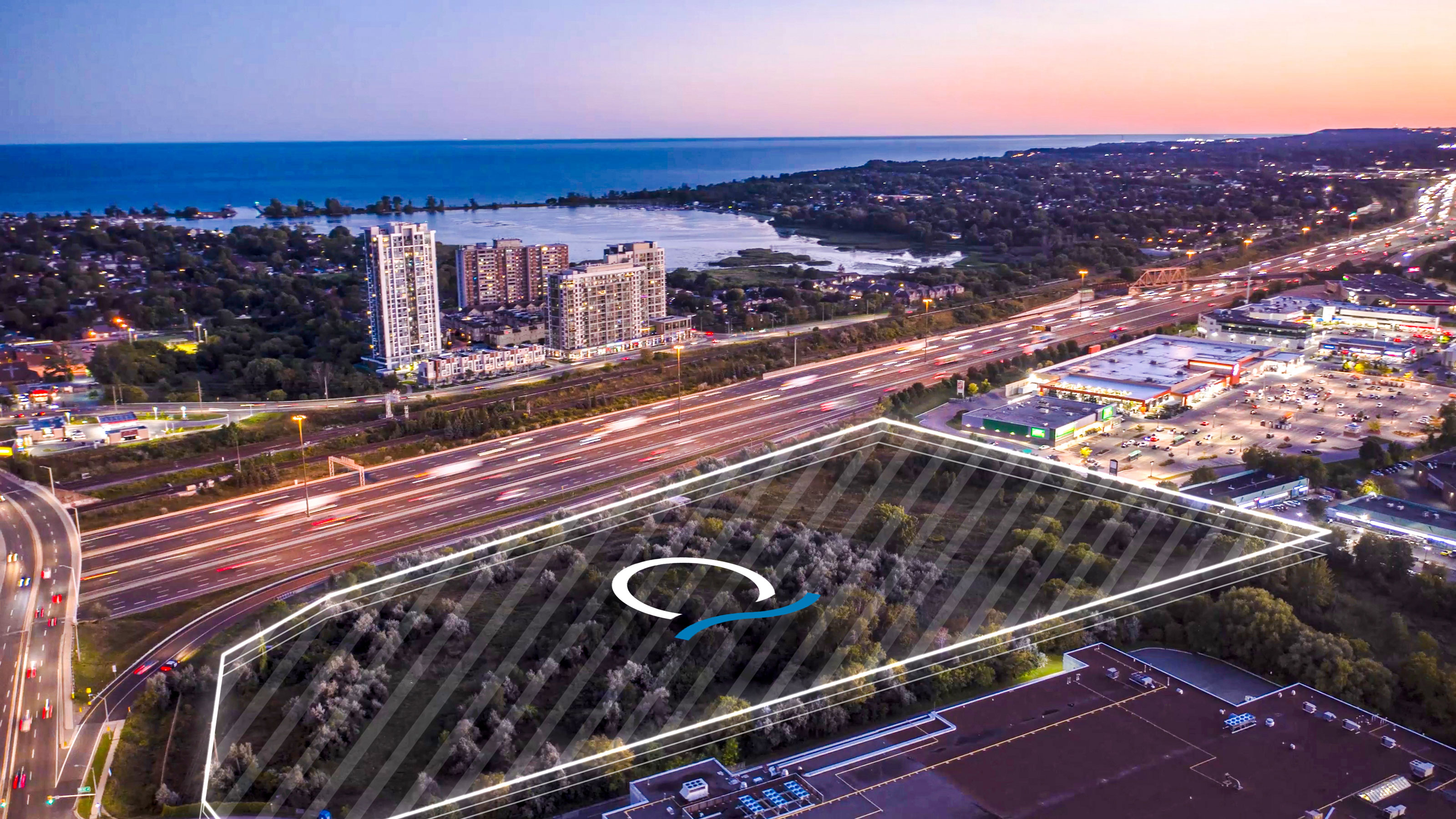 Aerial twilight view of the VuPoint site near Highway 401 with Lake Ontario in the distance