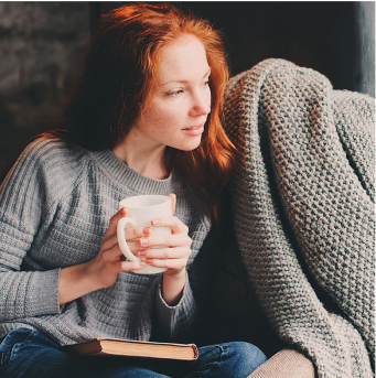 Relaxing at home with a book and coffee